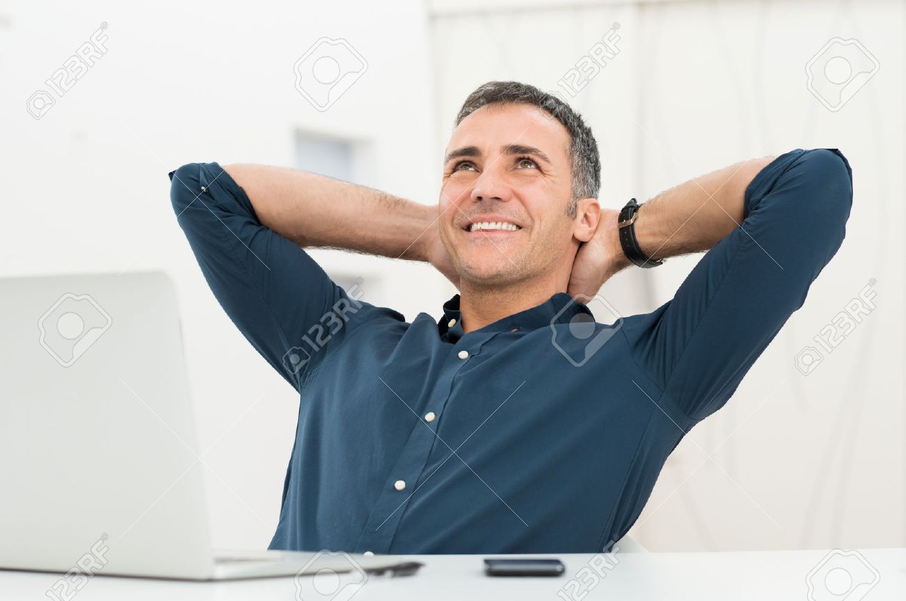 25271763-Mature-Man-Satisfied-Sitting-In-Front-Of-Laptop-Daydreaming-Stock-Photo.jpg